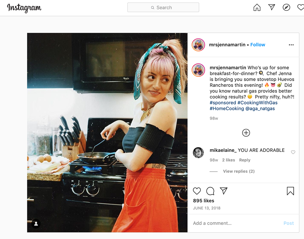A Instagram screenshot of a woman in a black top and red skirt cooking over a gas stove