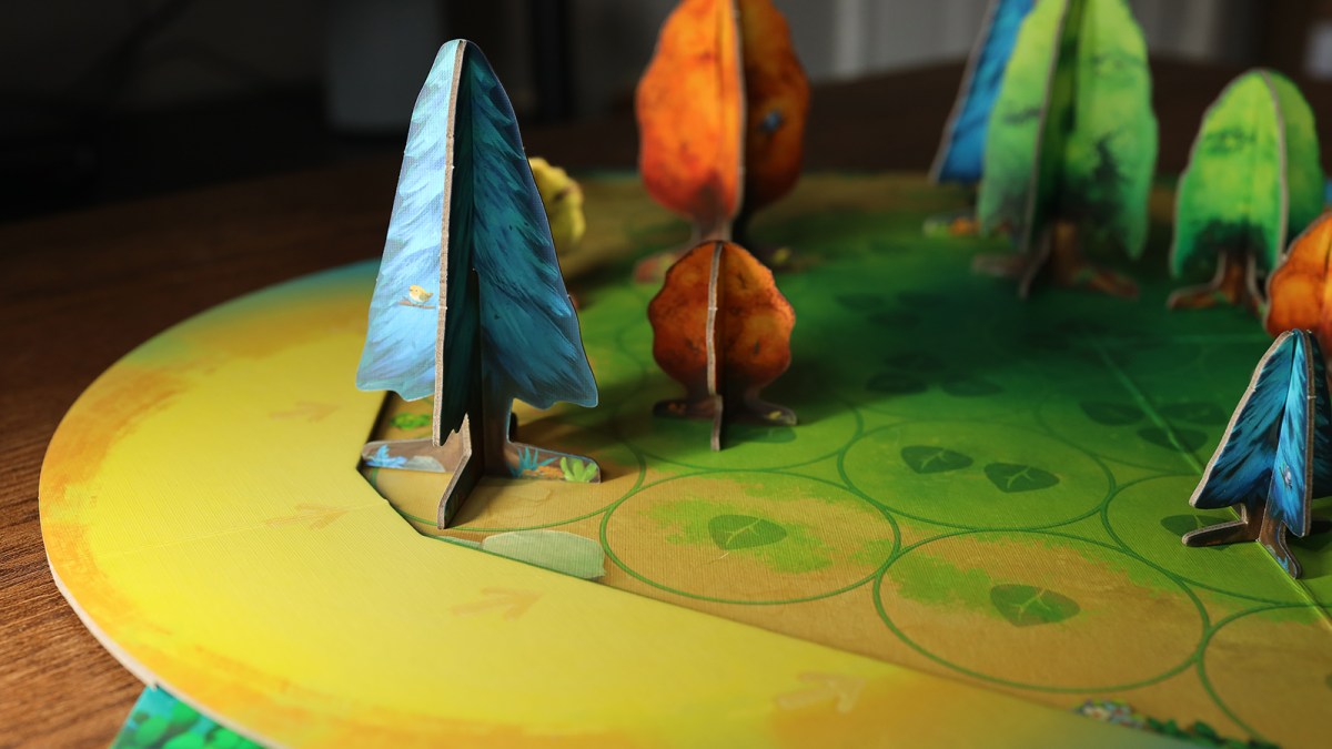 A photo of the game Photosynthesis shows tree-shaped game pieces "shading out" other trees on the board.