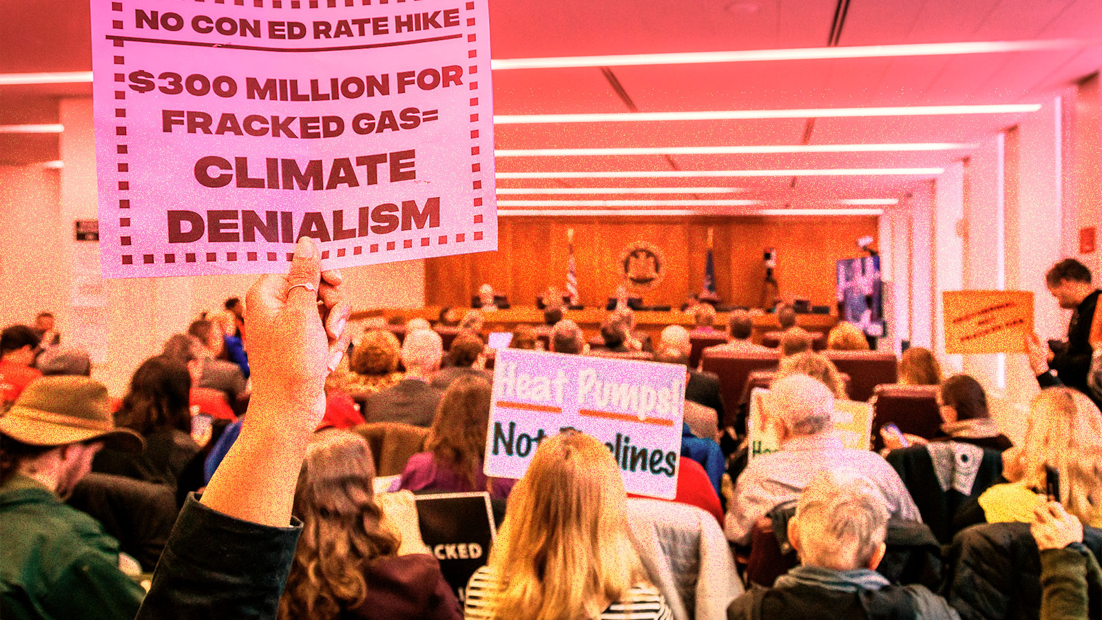 photo of protesters holding anti-fracking signs at Con Edison PSC meeting