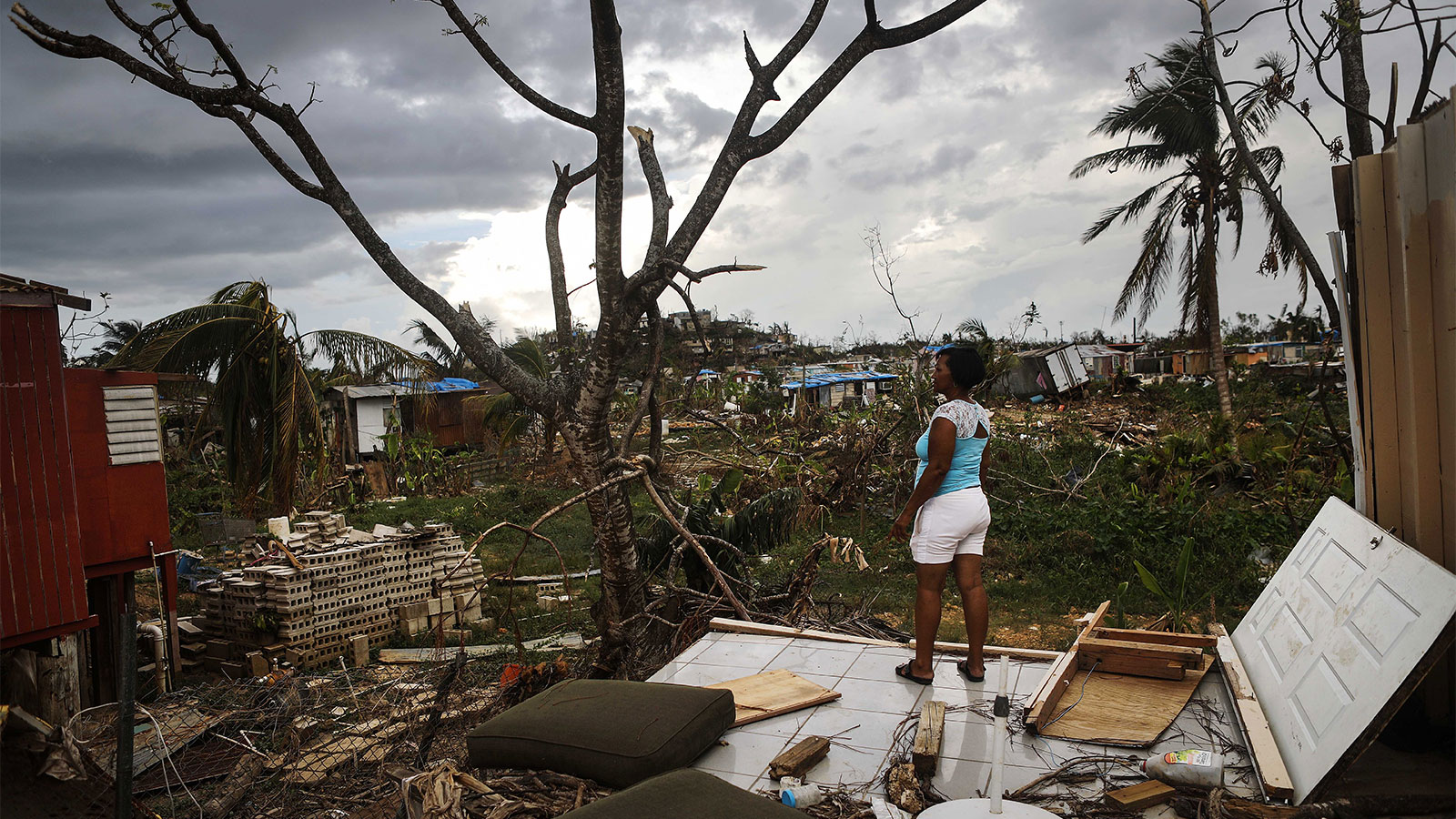 Resident Mirian Medina stands on her property about two weeks after Hurricane Maria swept through the island on October 5, 2017 in San Isidro, Puerto Rico