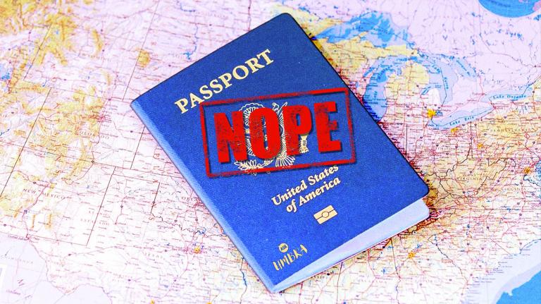 A US passport with the word "nope" stamped on it on top of a map.