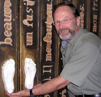 A photo of Rees holding white footprints.