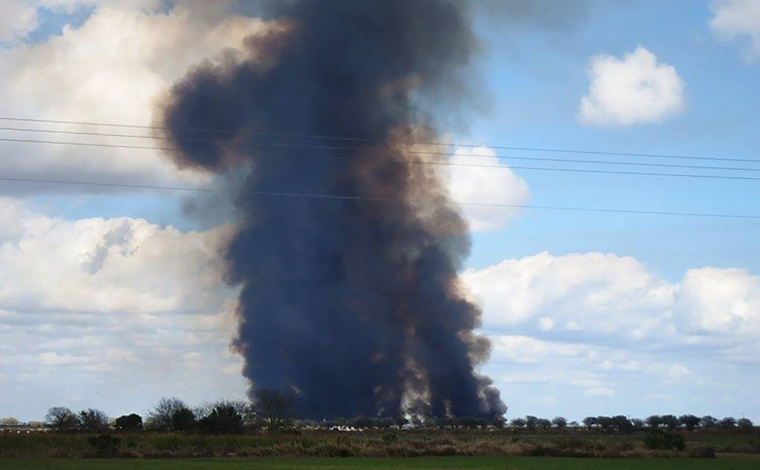 A plume of black smoke rises from a sugarcane burn outside of Clewiston, Florida.