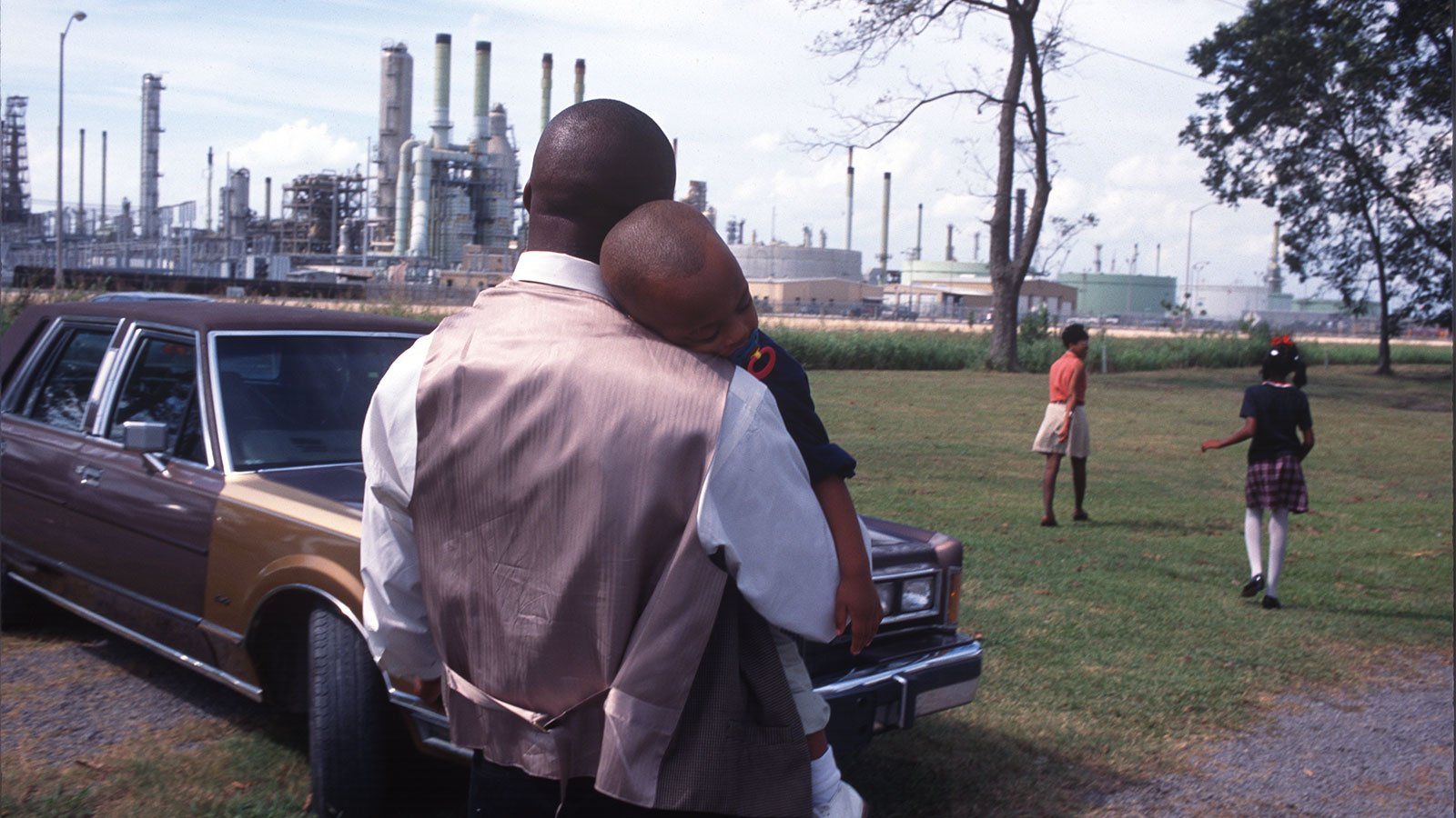 A family leaves Sunday church services surrounded by chemical plants in October of 1998 in Lions, Louisiana.