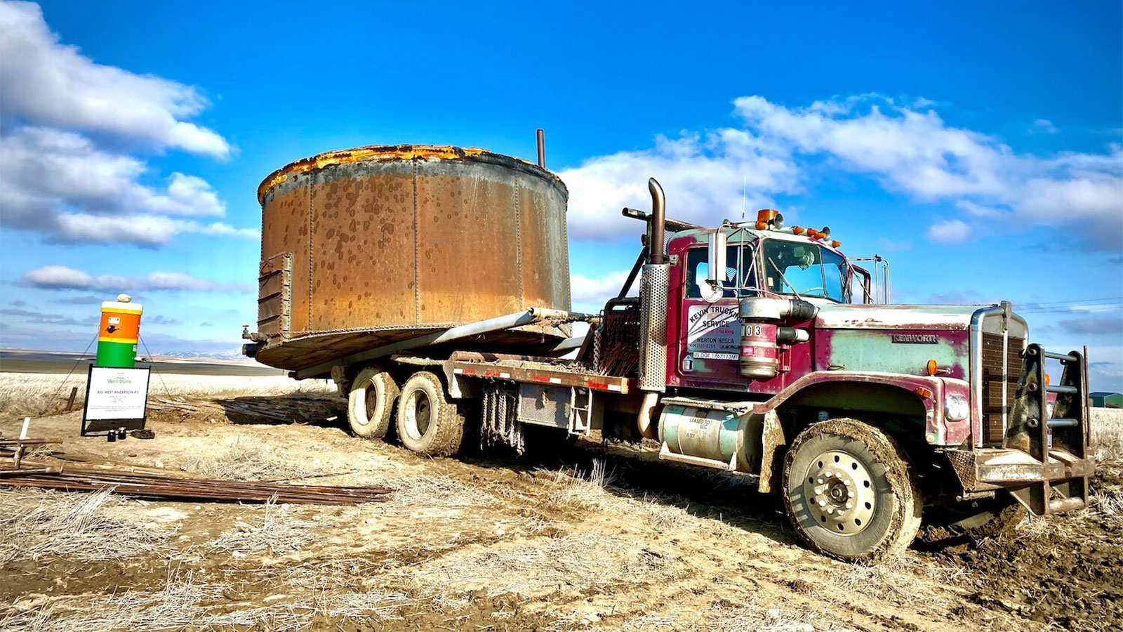 photo of truck pulling large oil tank