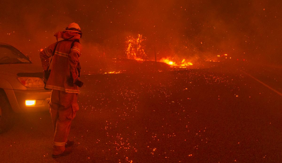 SHAVER LAKE, CA - SEPTEMBER 8: Embers fall around a photographer as the Creek Fire rapidly expands on September 8, 2020 near Shaver Lake, California. California Gov. Gavin Newsom declared a state of emergency in five California counties late yesterday as record heatwave temperatures fueled numerous wildfires over the Labor Day weekend. The state of emergency applies to Fresno, Madera and Mariposa, San Bernardino and San Diego counties. The Creek Fire has burned across more than 135,523 acres and is zero percent contained. (Photo by David McNew/Getty Images)