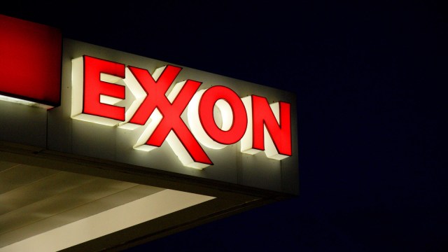 An Exxon gas station sign against a dark night sky