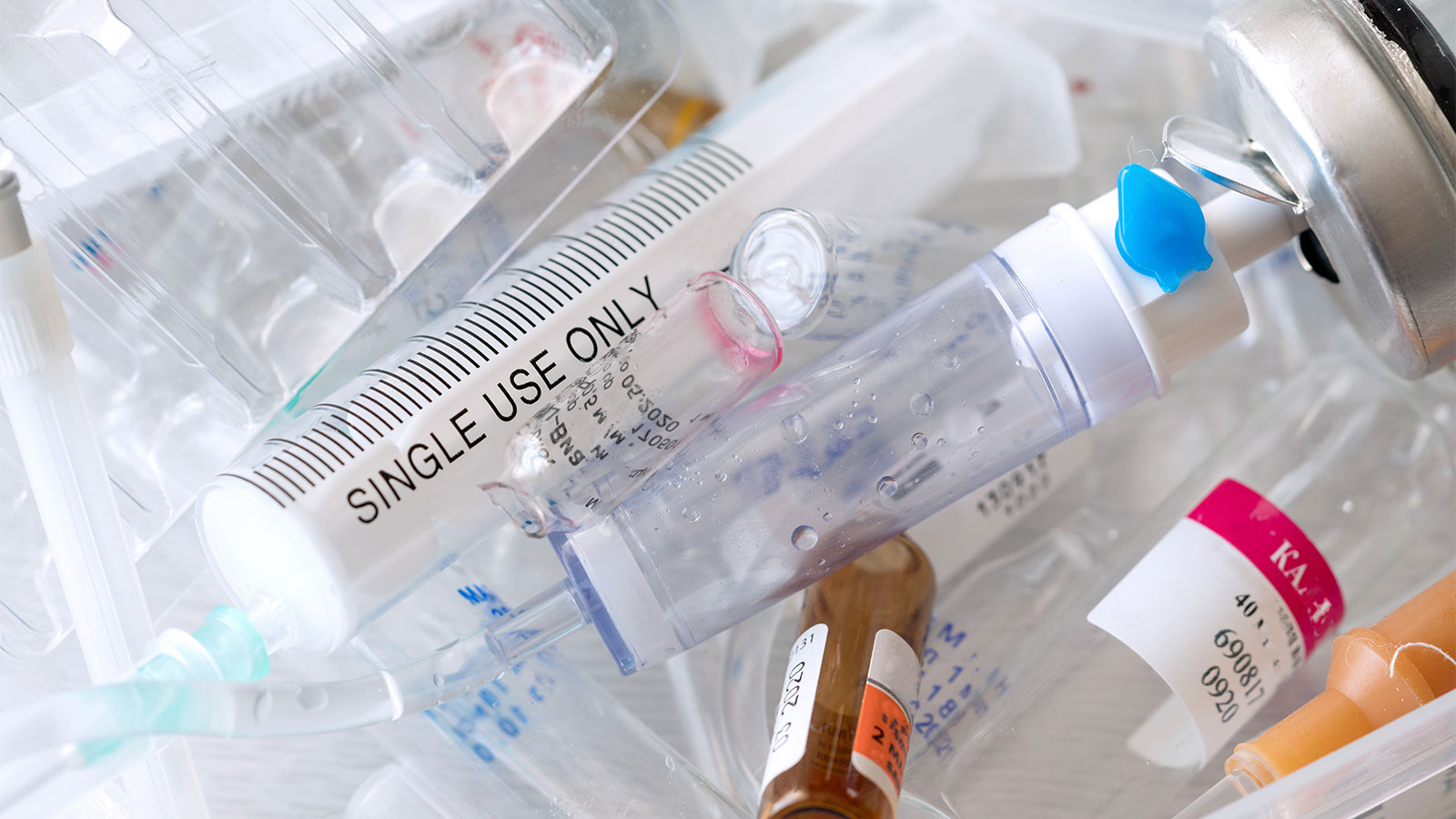Close up photo of used medical syringes and ampoules