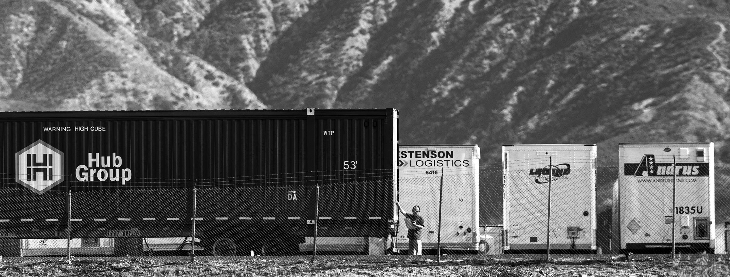 A lone trucker at work. San Bernardino has long been a transportation/distribution hub for the west coast of the United States. Trains, trucks, airplanes all converge there to distribute goods creating a heavy pollution burden on the area. In addition, much of the pollution from the LA/Orange County basin gets trapped there by converging mountain ranges as daily ocean winds push pollutants inland.