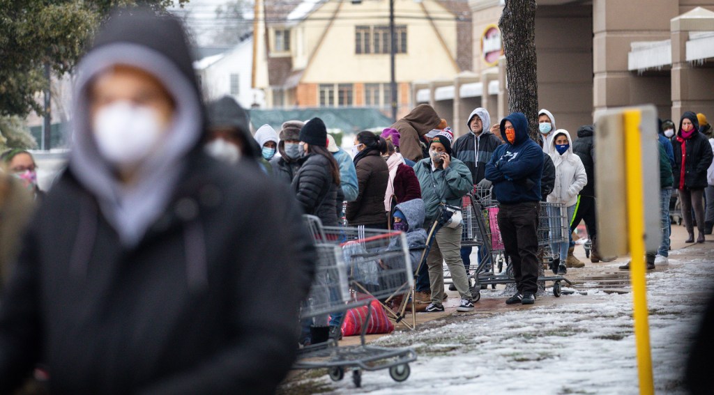 AUSTIN, TX - FEBRUARY 17, 2021: People wait in long lines at an H-E-B grocery store in Austin, Texas on February 17, 2021. Millions of Texans are still without water and electric as winter storms continue.
