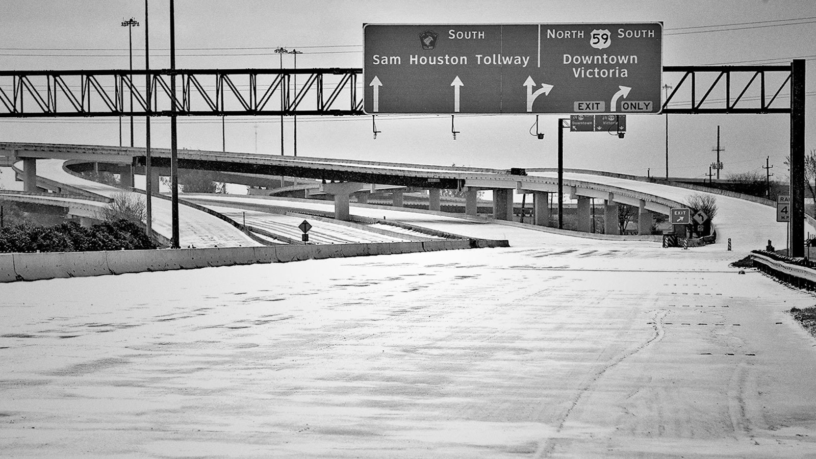Black and white photograph of an ice covered, closed highway in Houston, Texas.