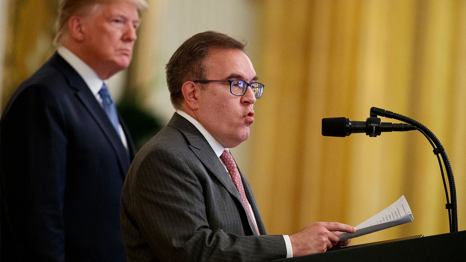 A photograph of President Donald Trump listening as Environmental Protection Agency Administrator Andrew Wheeler speaks during an event on the environment in the East Room of the White House, Monday, July 8, 2019, in Washington.