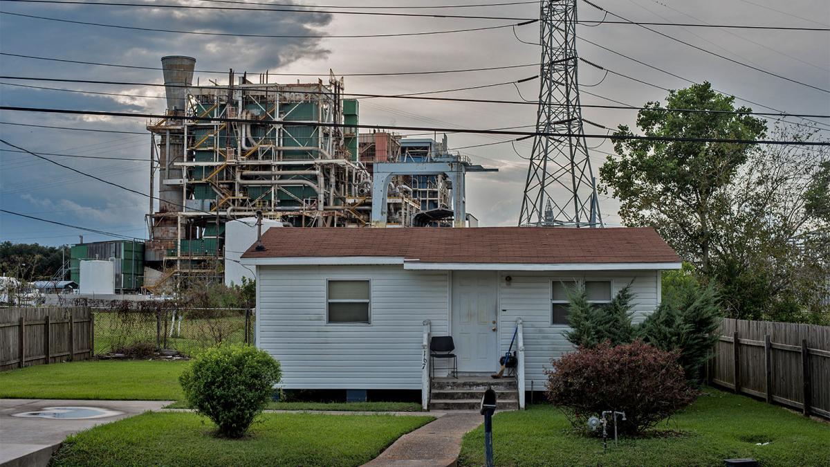 A house in front of a refinery in what is known as "cancer alley" in Louisiana