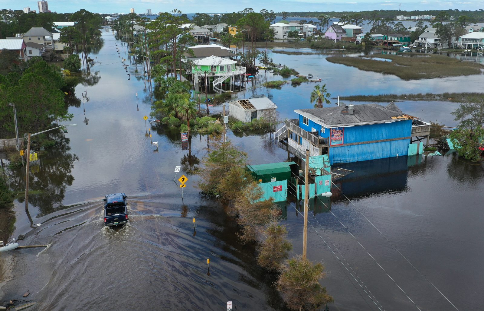 An aerial view from a drone shows a vehicle driving through a flooded street after Hurricane Sally passed through the area on September 17, 2020 in Gulf Shores, Alabama. The storm came ashore with heavy rain and high winds.