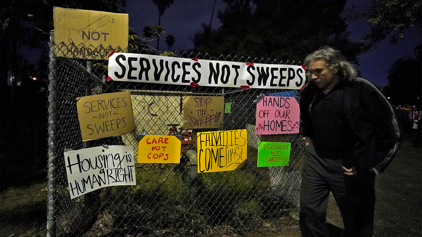 Signs on a chain link fence protesting the eviction of Echo Park