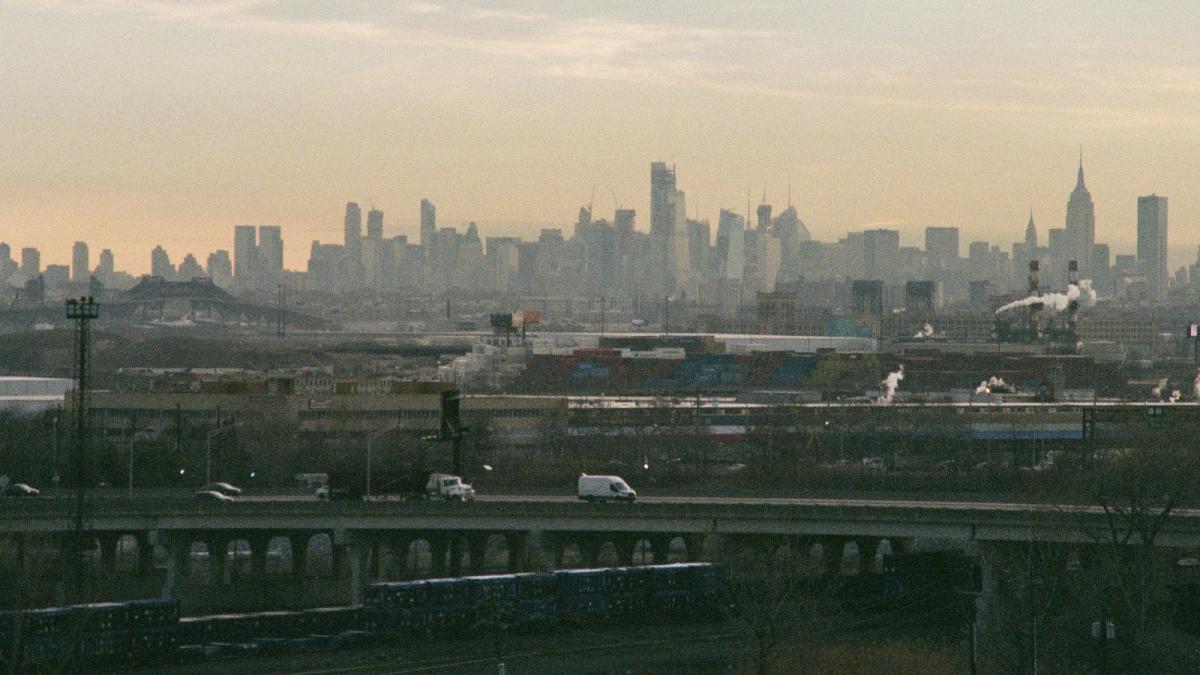 Cars driving on highway with skyline in background