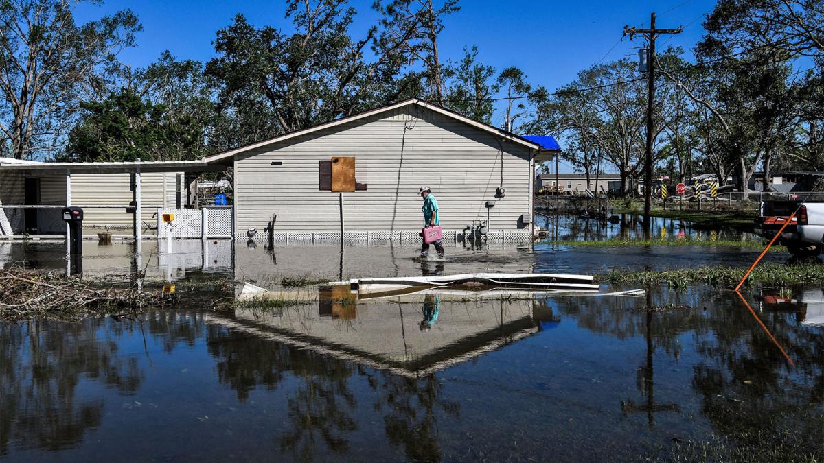 A man in front of his house in flooded Lake Charles, Louisiana