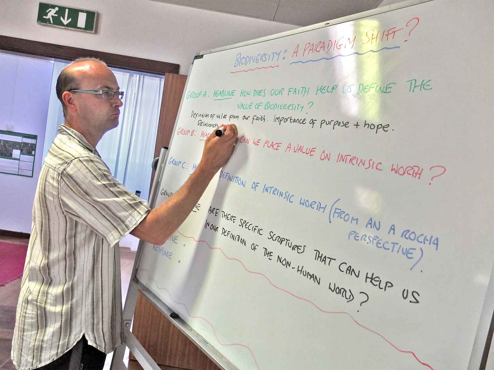 An A Rocha volunteer takes notes during a brainstorm on religion and biodiversity at a leader’s forum in Portugal.