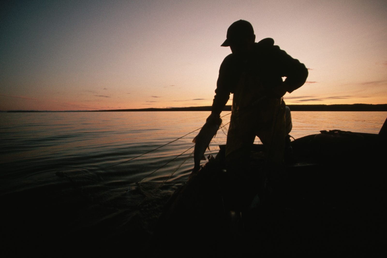 A silhouette of a Great Lake fisherman.