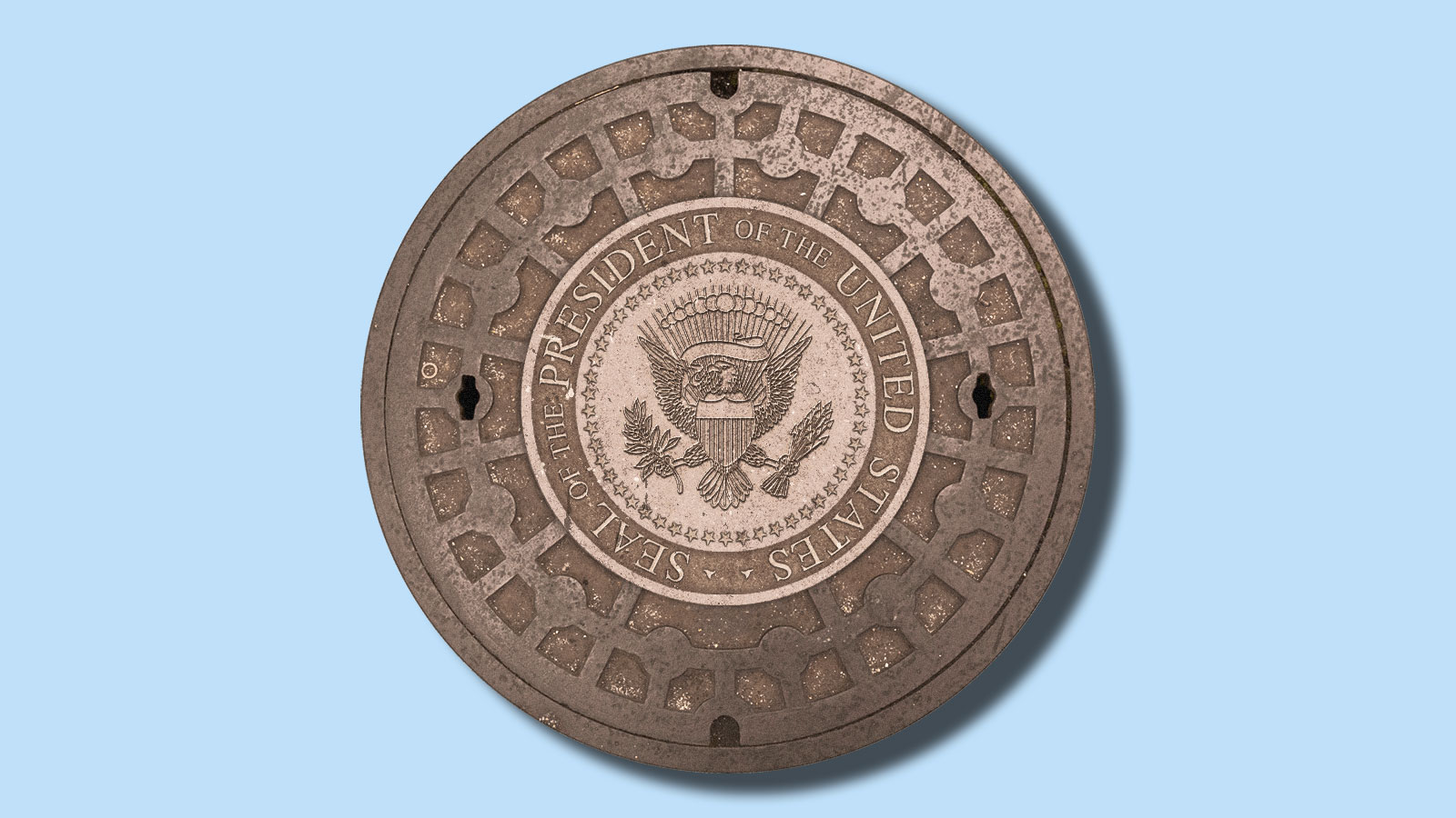 A manhole cover with the seal of the President of the United States embossed on it