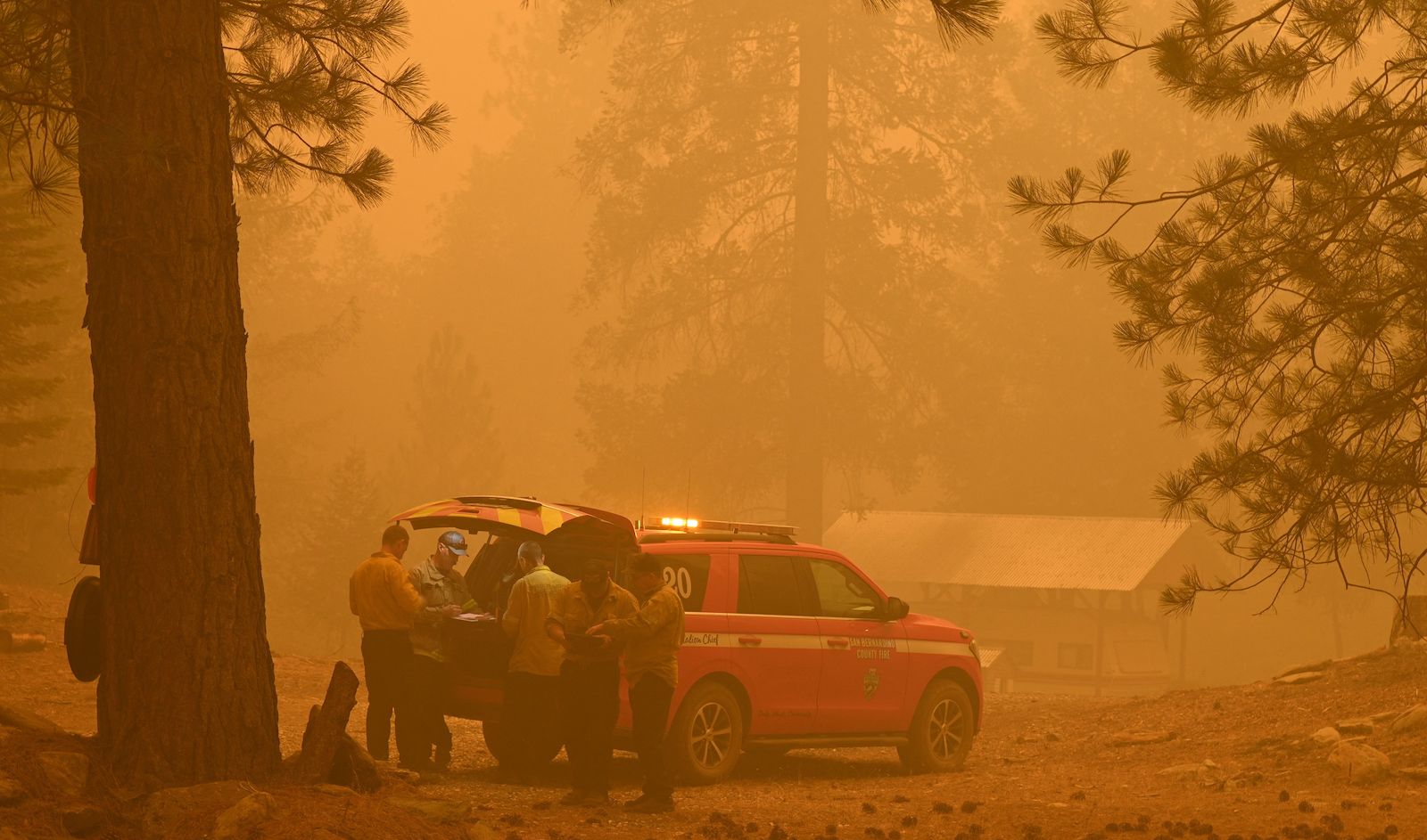Firefighters fight the Dixie Fire on July 26 amid smoky skies.