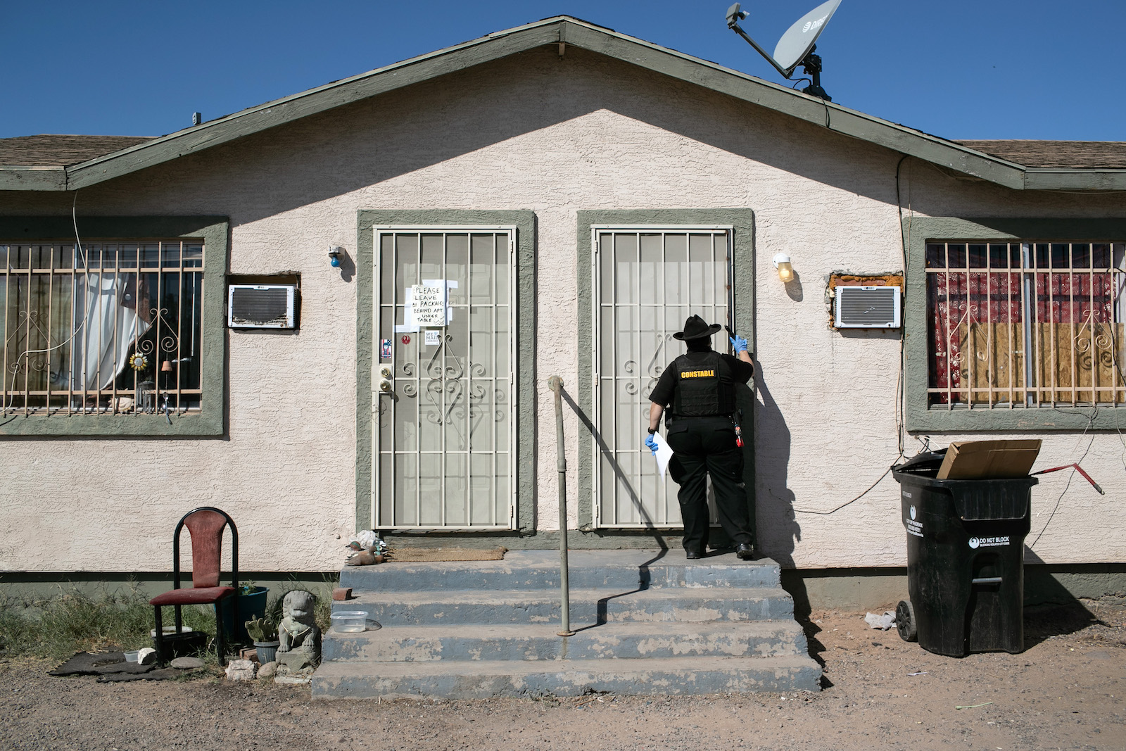 Maricopa County constable Darlene Martinez knocks on a door before posting an eviction order on October 1, 2020 in Phoenix, Arizona.