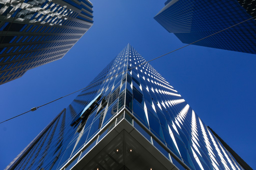 Three skyscrapers reach towards the sky