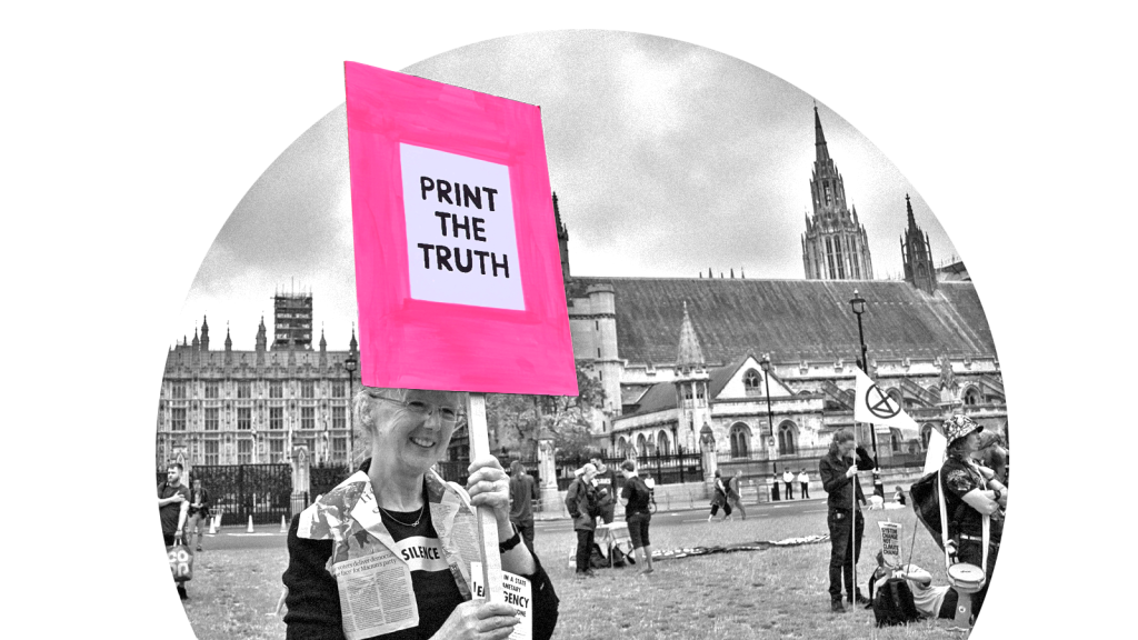 A woman at a protest holding a sign that says 