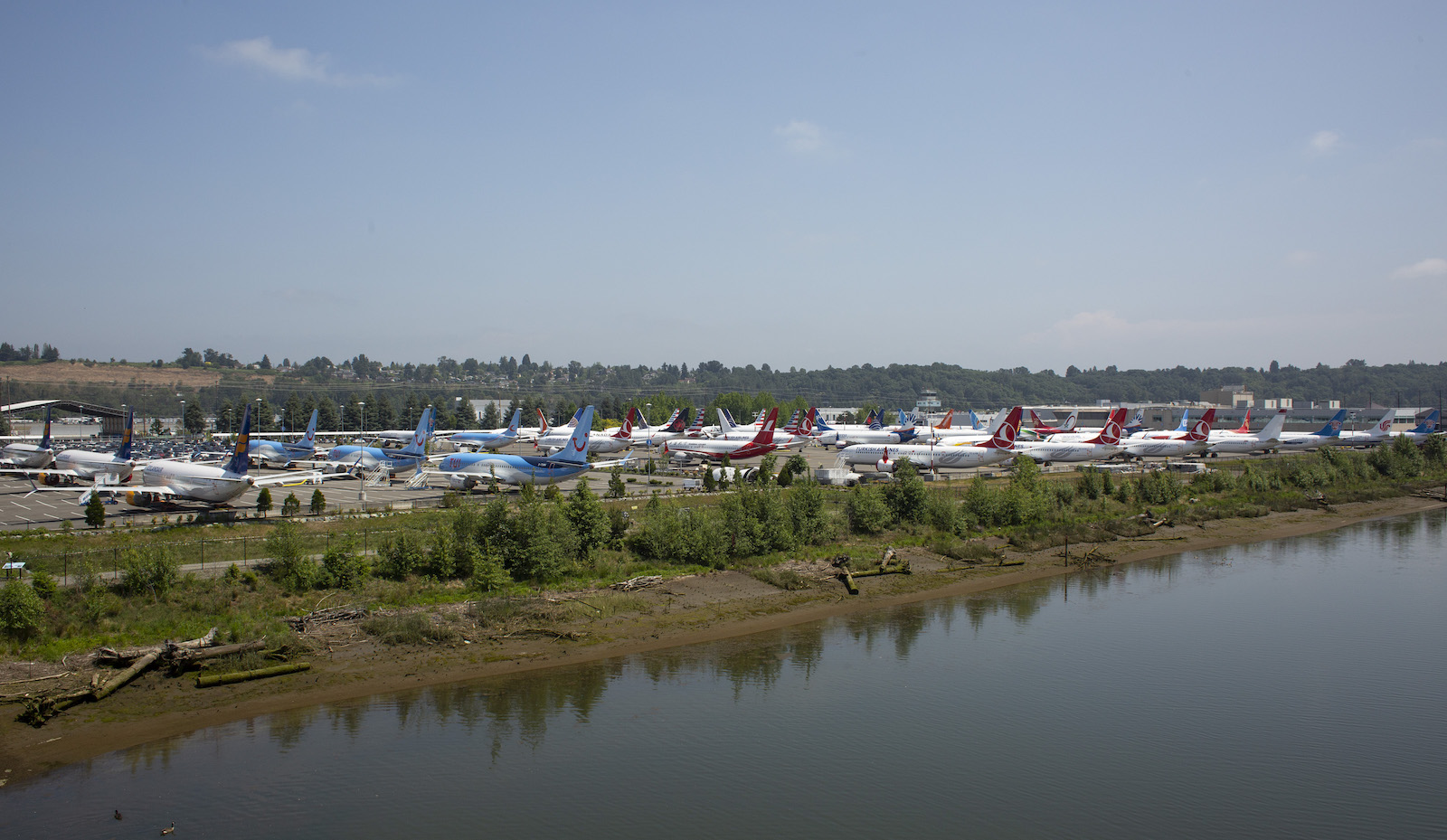 Airplanes are parked at a Boeing facility along the Duwamish River.