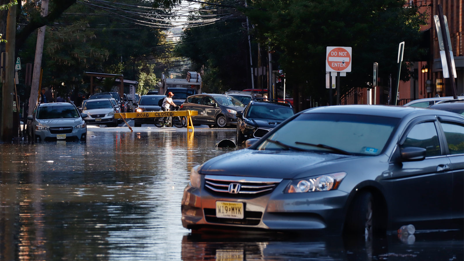 An abandoned car sits on a flooded street in Hoboken, New Jersey