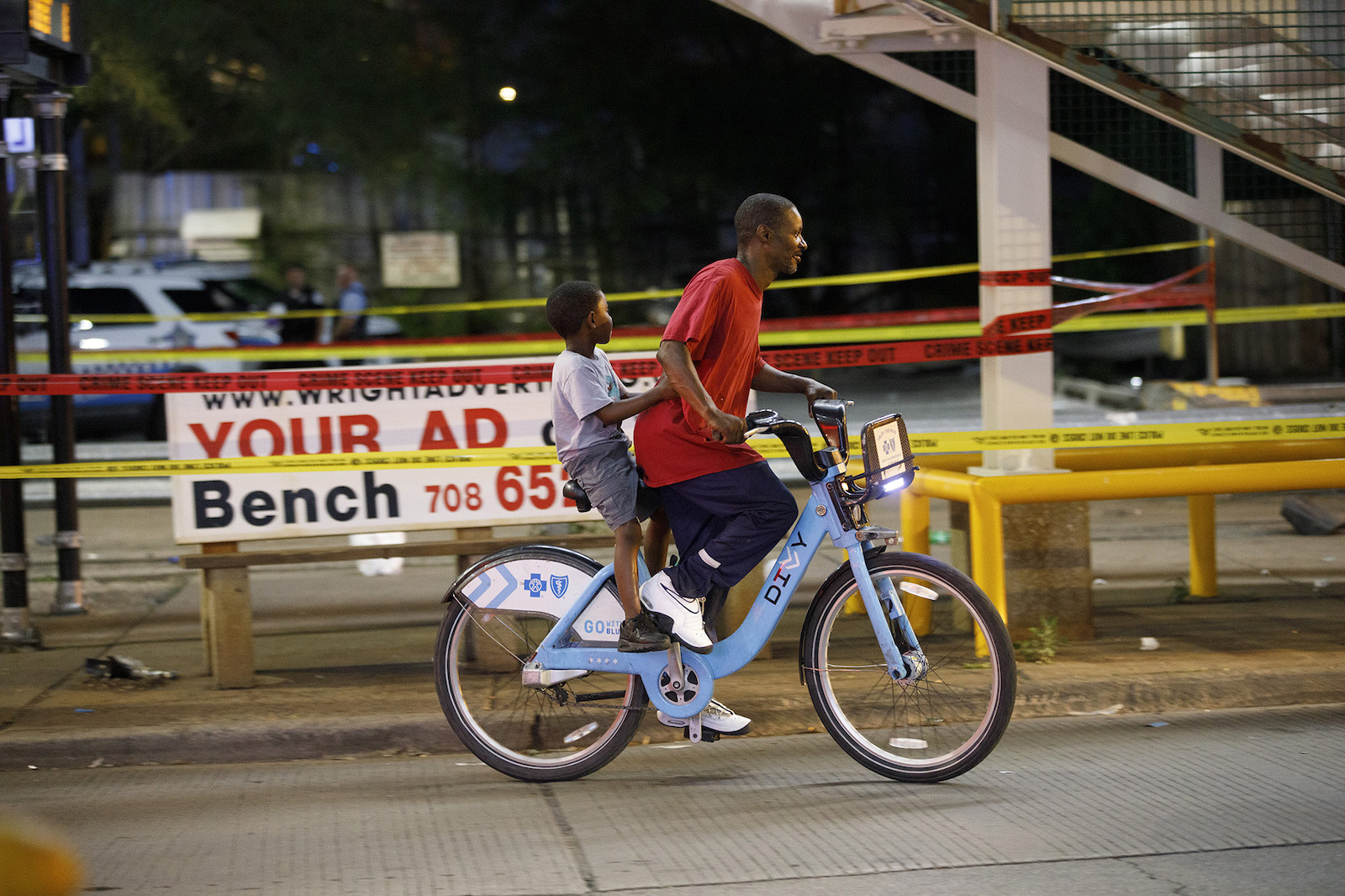 A man and child ride on a bike in Chicago.