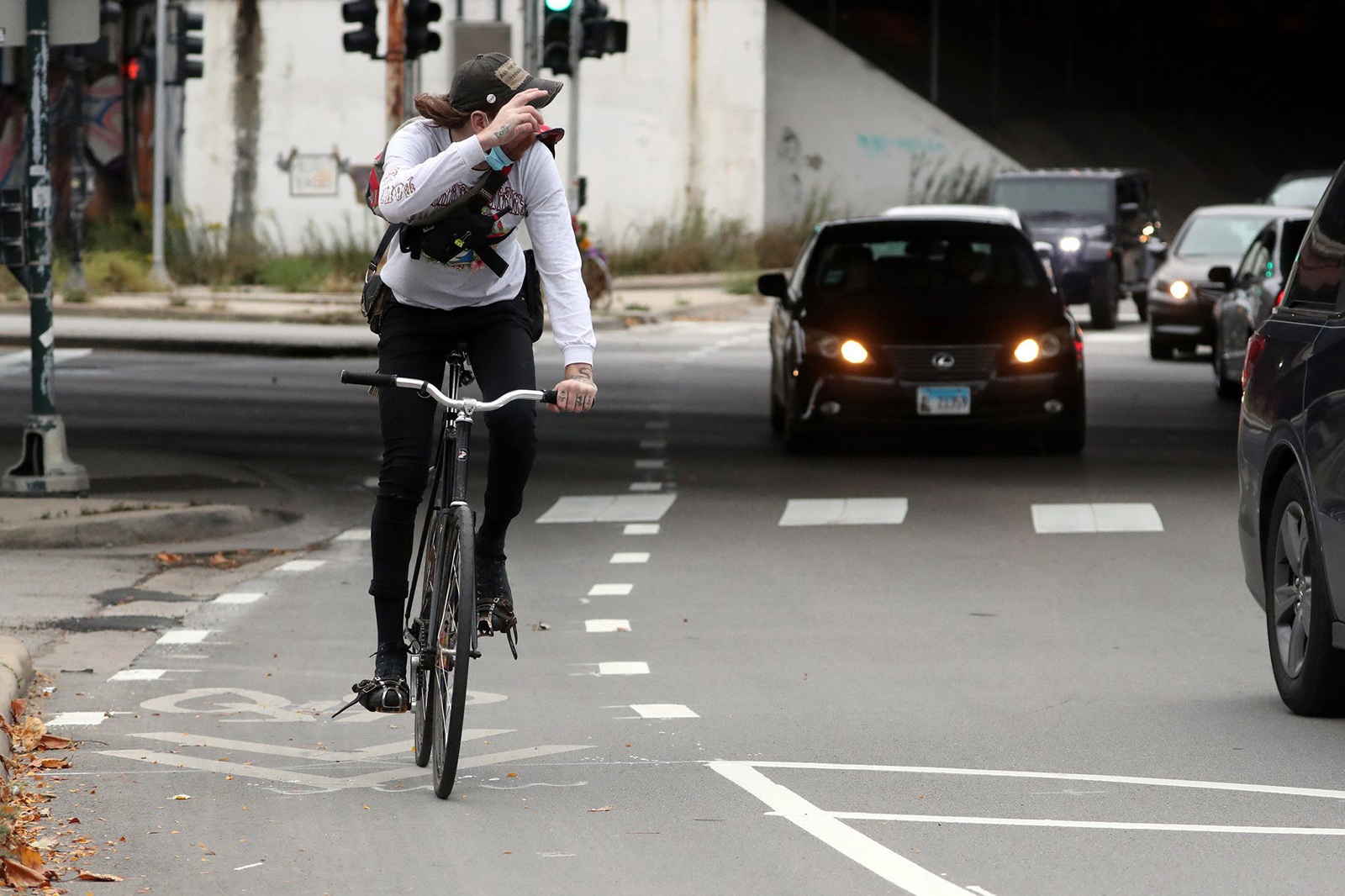 A man rides his bicycle in a bike lane