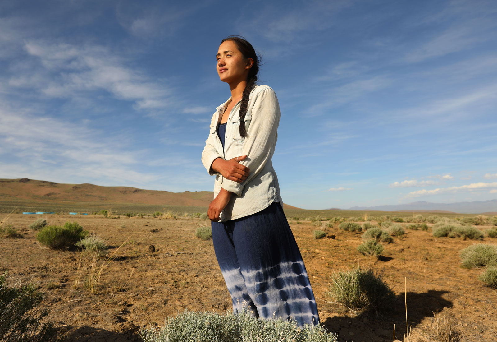 Daranda Hinkey, a member of the Fort McDermitt Paiute Shoshone tribe, stands in a field of sage brush