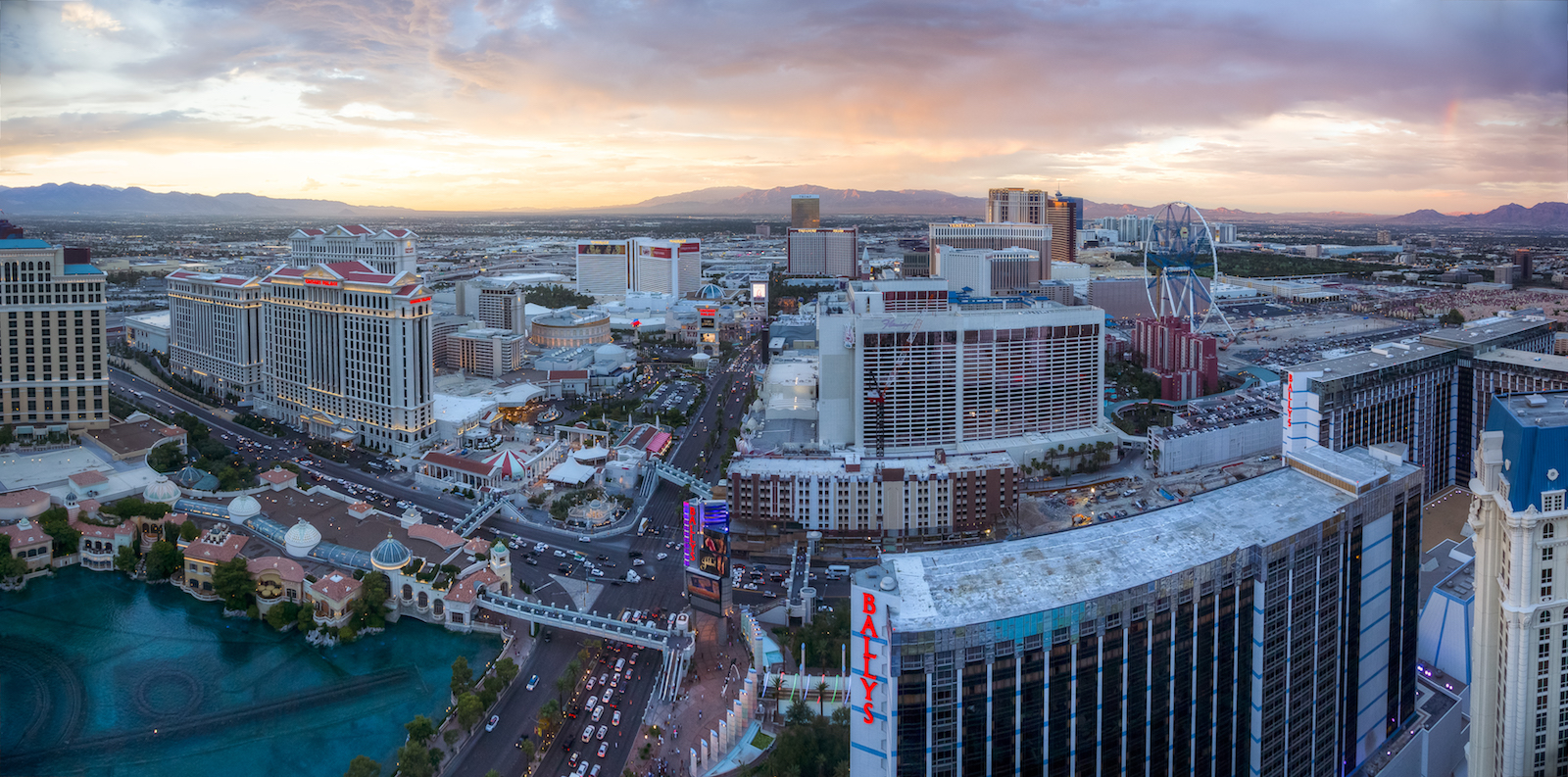 an aerial view of las vegas with large pools, buildings, and wide streets and a desert background