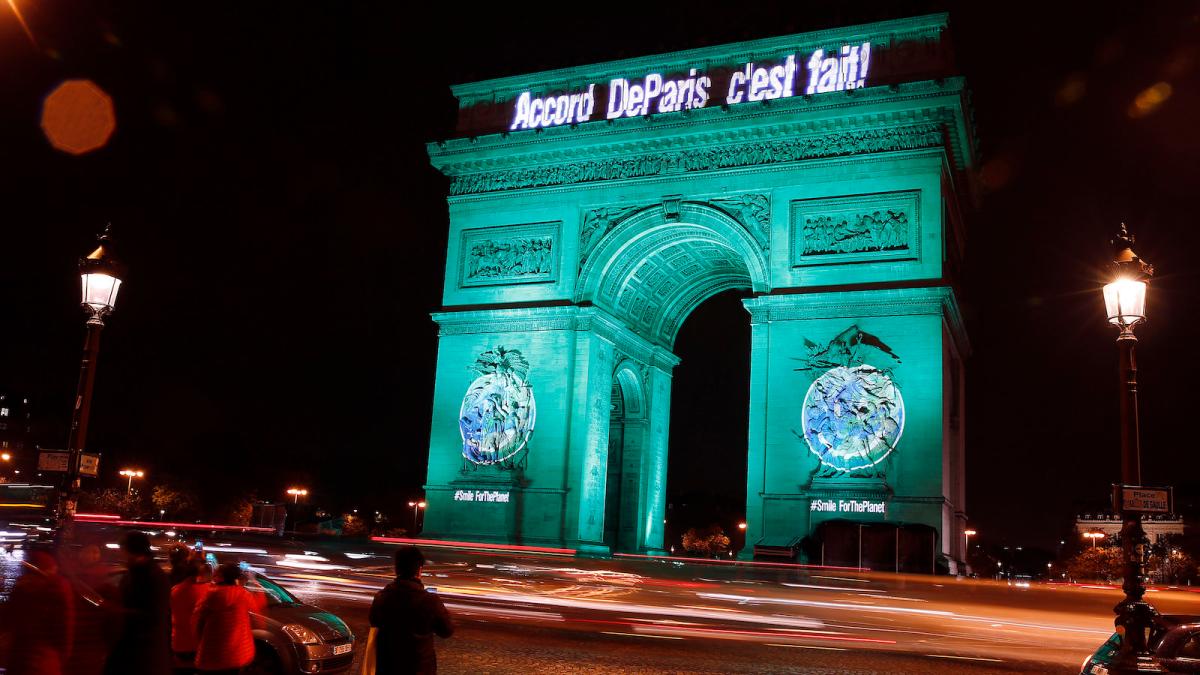 The Arc de Triomphe illuminated with the words "Paris Agreement is Done"