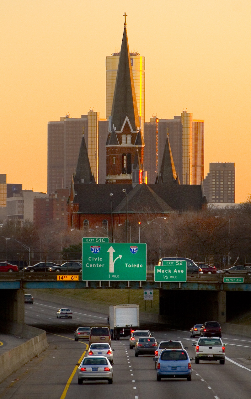 a church towers over a freeway overpass with 375 and 75 split