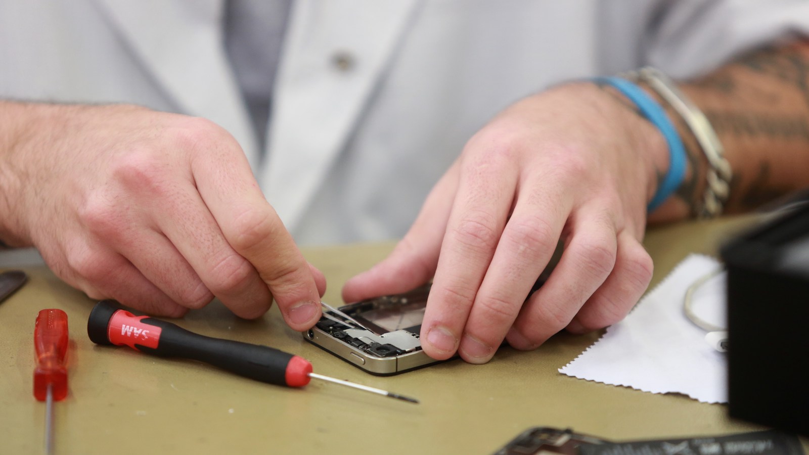 A technician repairs an iPhone