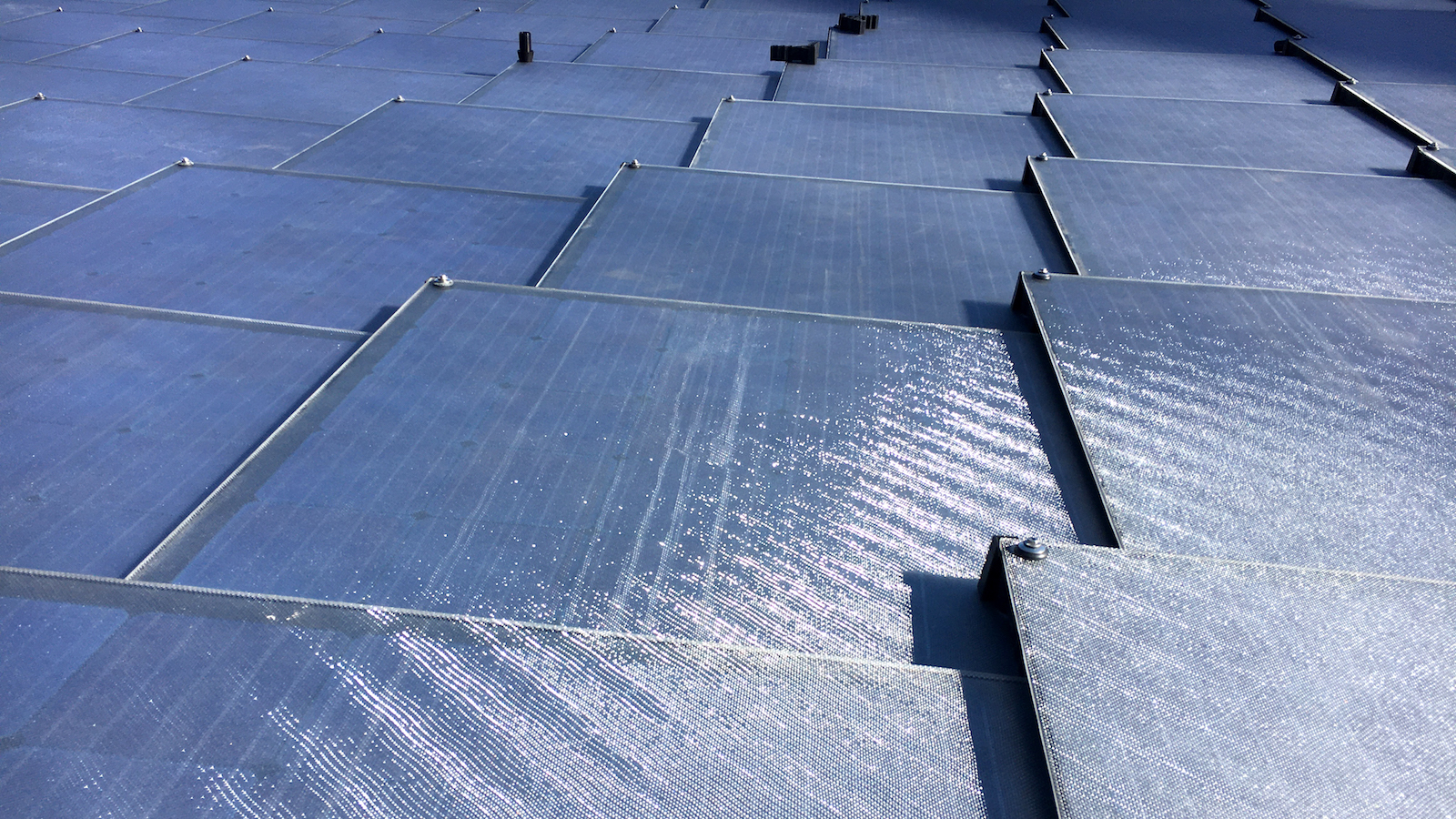 an overlapping close up grid of solar shingles