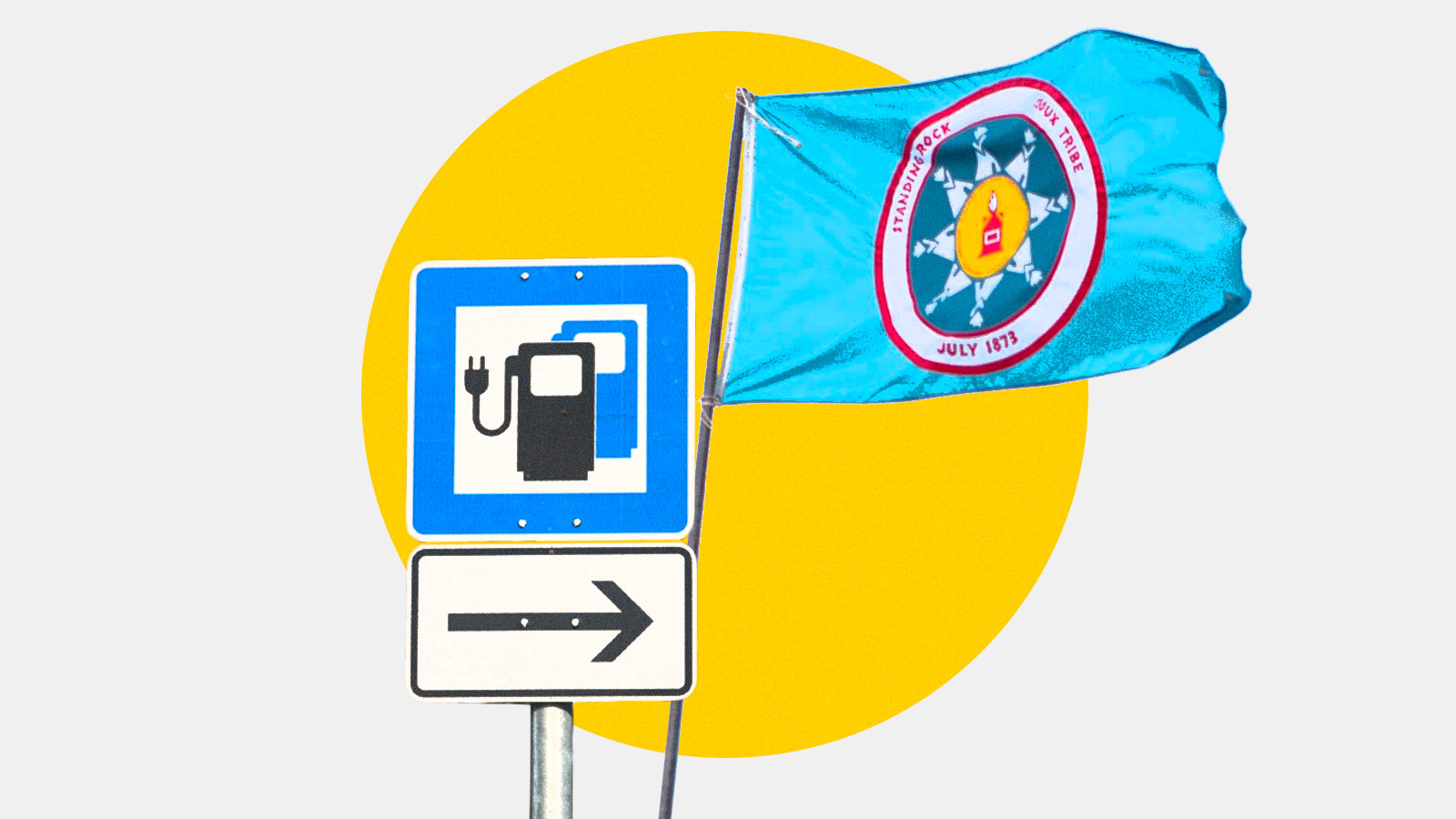 An electric vehicle charging station sign and the Standing Rock Sioux Tribe flag