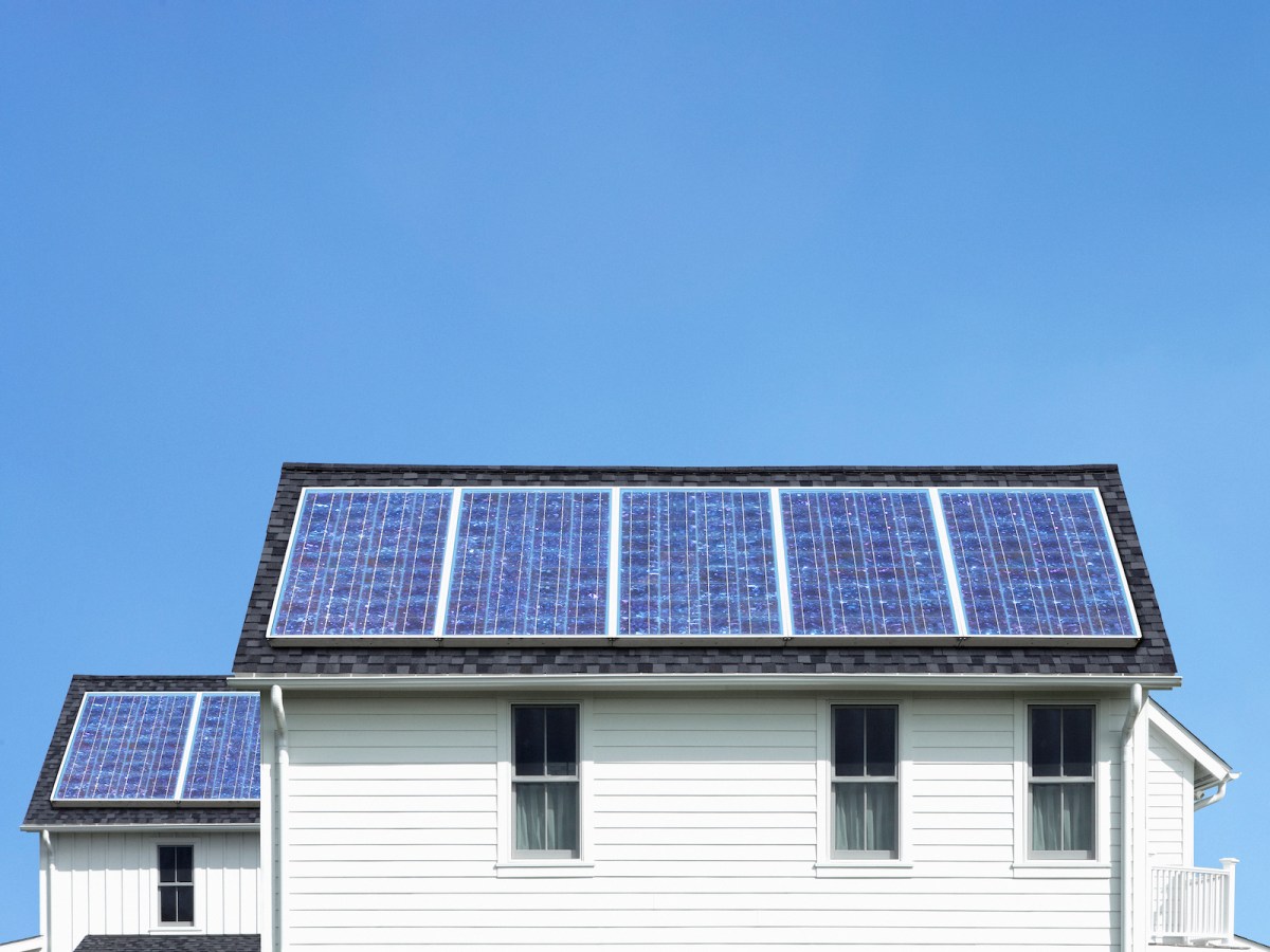 Solar panels on roof of white house