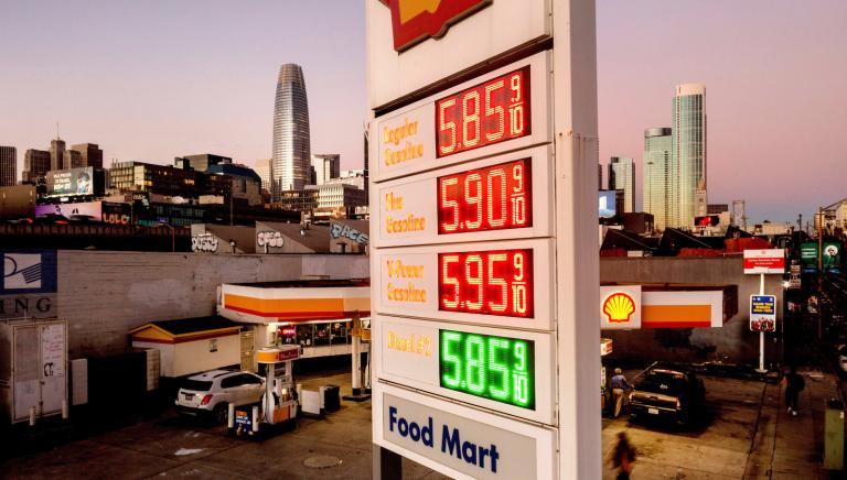 a sign at a Shell gas station lists gas prices as high as $5.85
