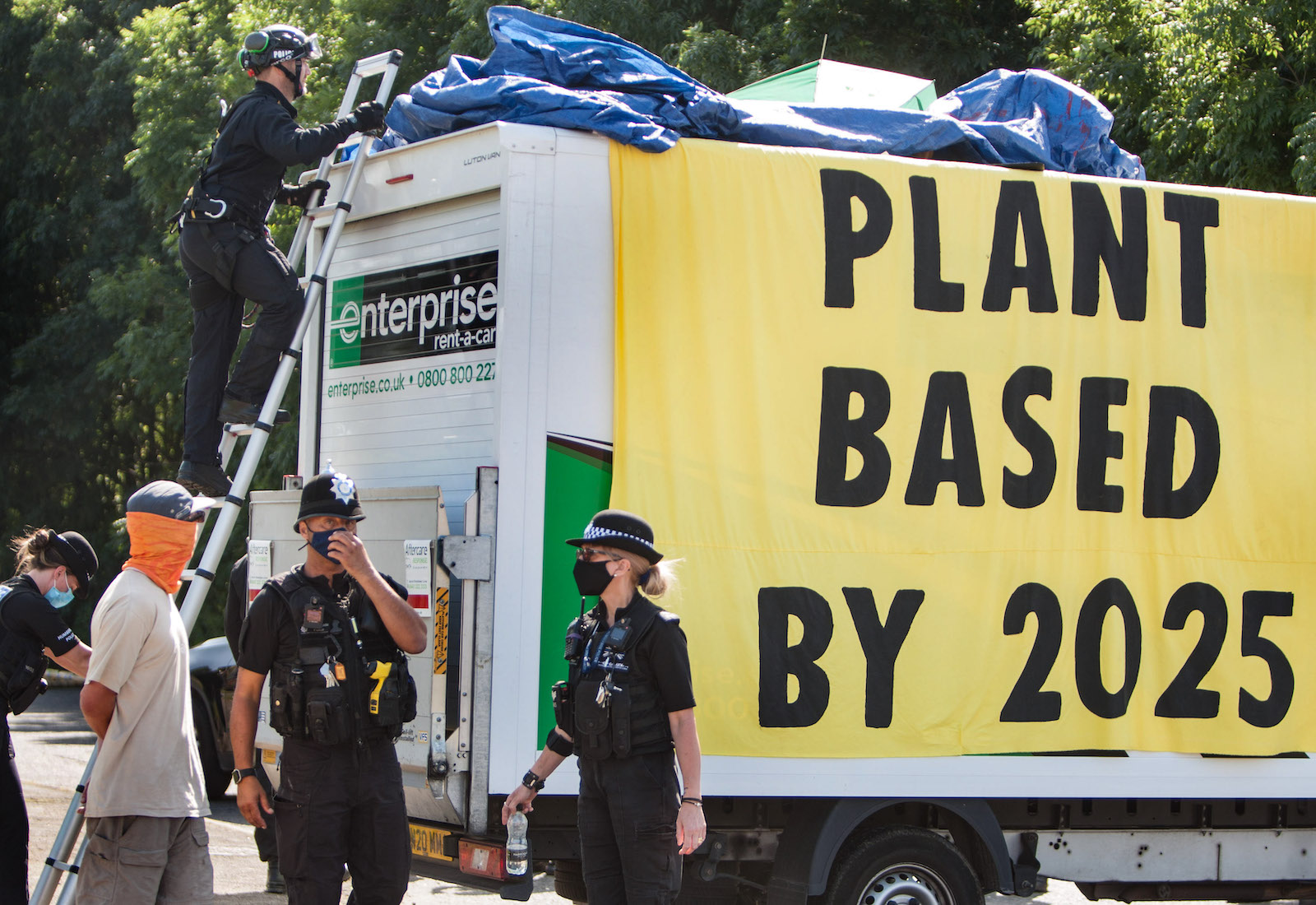 A sign reads "Plant-based by 2025"