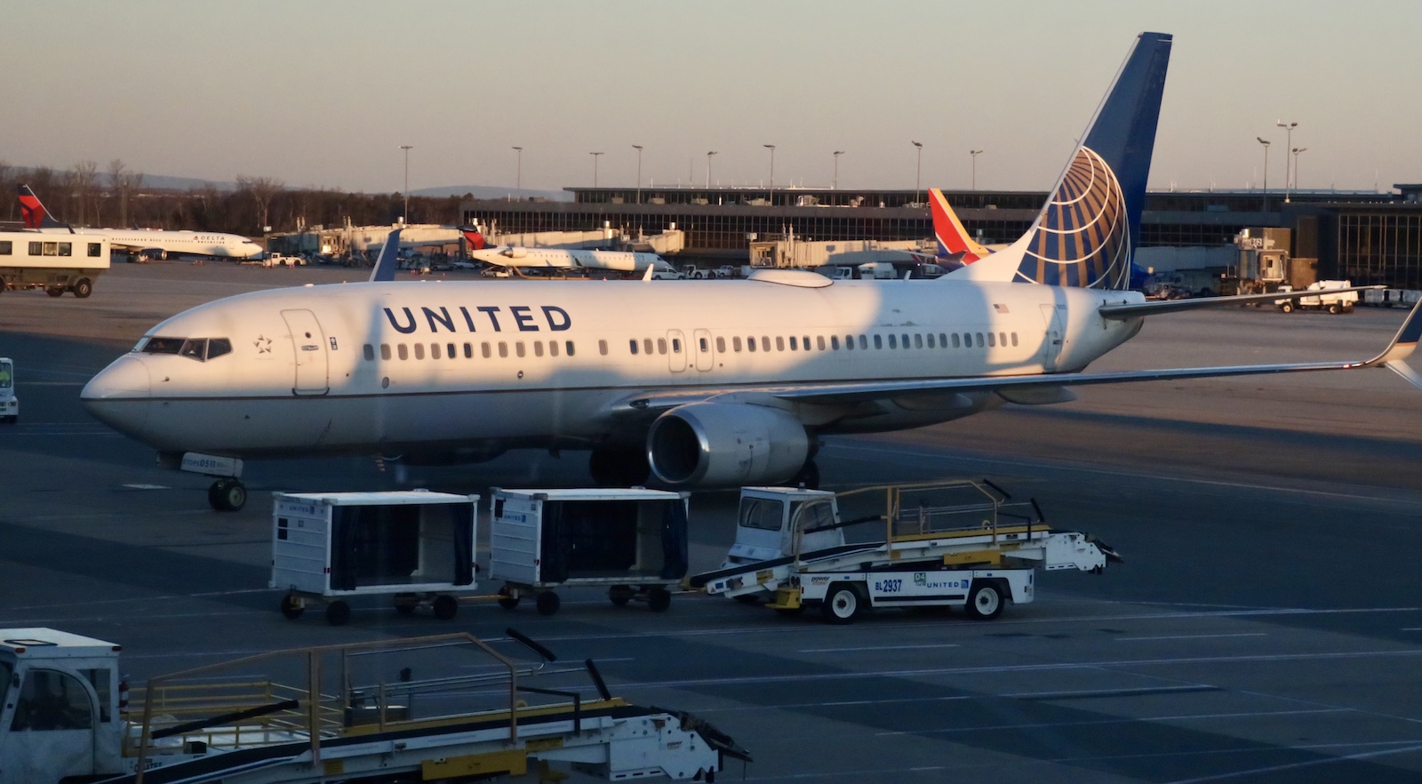 a united airlines plan sits at an airport gate