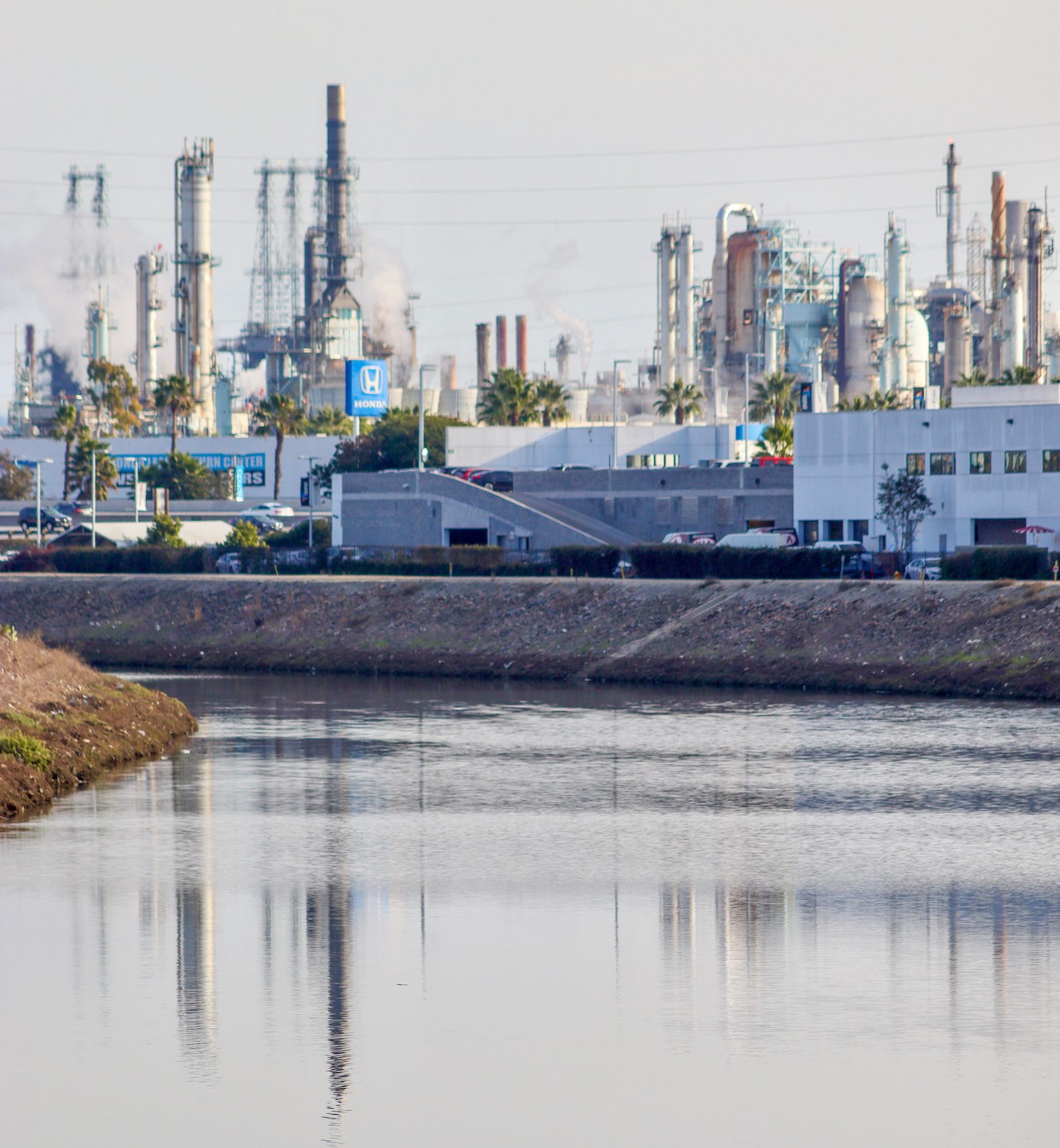 The Marathon Refinery towers over the Dominguez Channel in Carson, California.