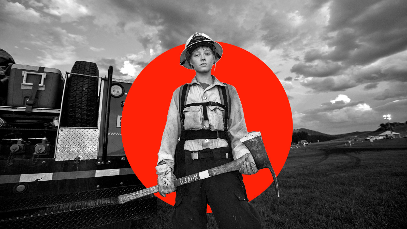 Black and white photo of a female firefighter in front of a red circle