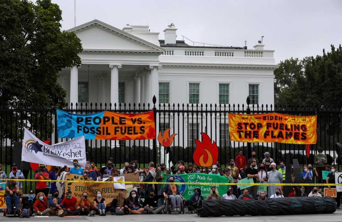 Protesters in front of white house with signs and banners