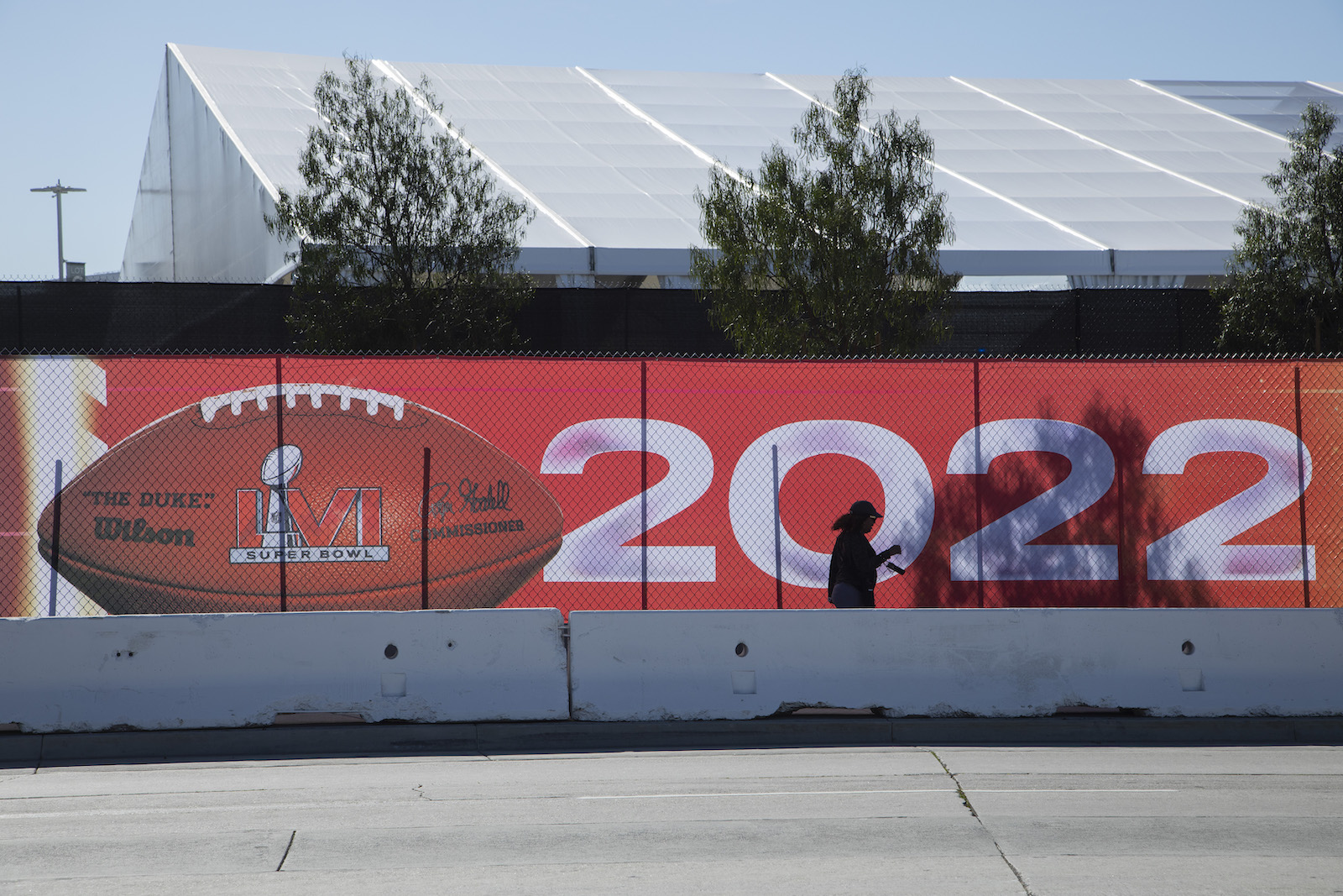 Event tents and stages at SoFi Stadium will worsen the scarcity of parking spaces for Super Bowl Sunday. Nearby home and business owners will open their property for parking but for a very steep price.