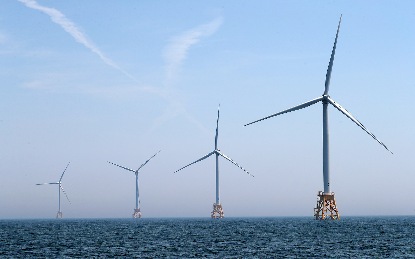 Four wind turbines in the ocean
