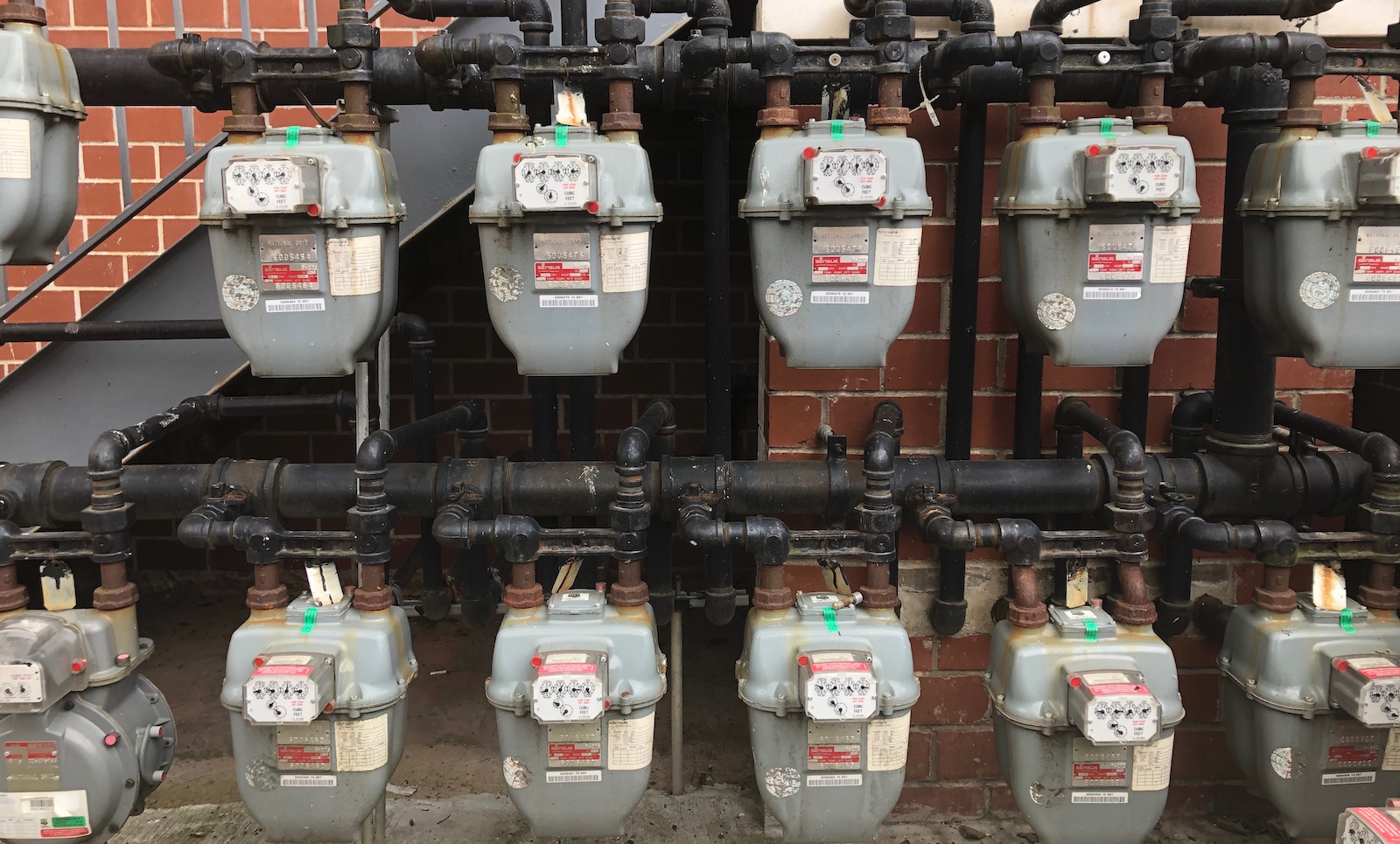 a line of gas meters outside a building