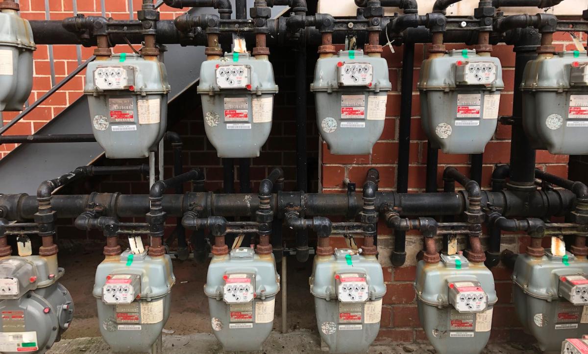 a line of gas meters outside a building